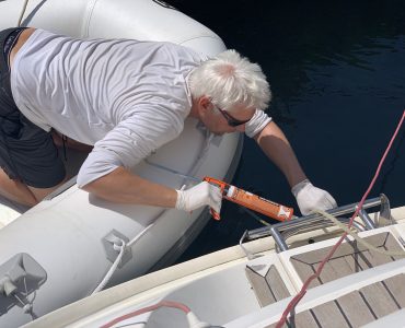 Man repairing a sail boat